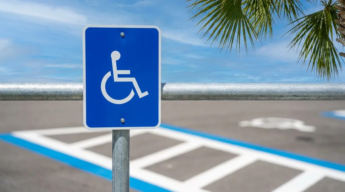 New accessible parking sign on a steel post